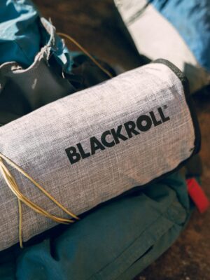Close-up of hiking equipment featuring a Blackroll accessory, perfect for outdoor adventures.